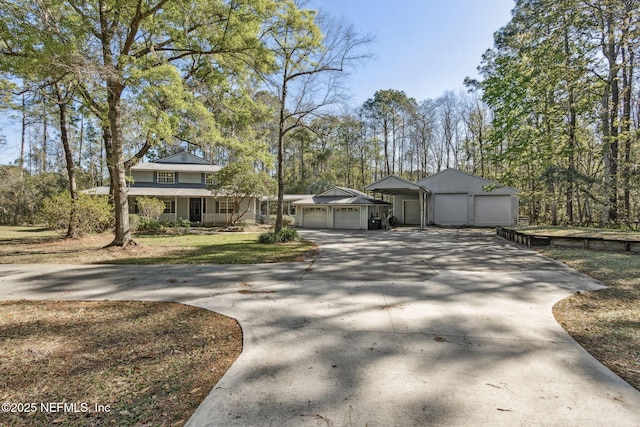 view of front of house featuring an outbuilding, a porch, and driveway