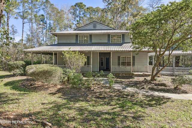 country-style home with covered porch and metal roof