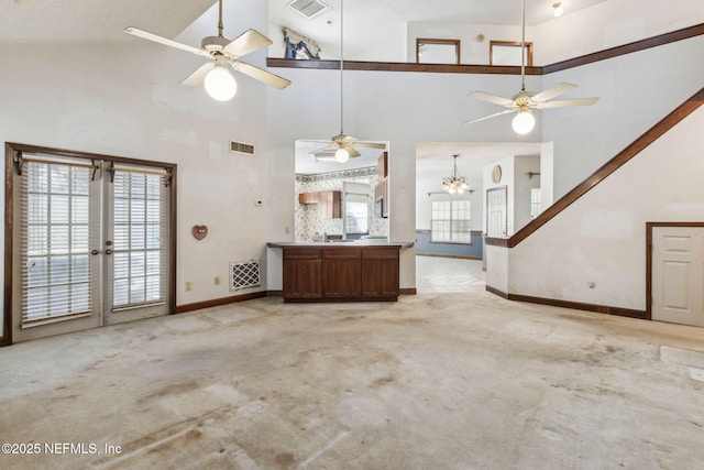 unfurnished living room featuring light carpet, visible vents, and ceiling fan