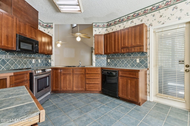 kitchen featuring wallpapered walls, black appliances, a textured ceiling, and a sink