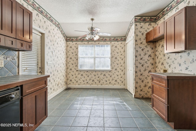 kitchen featuring a textured ceiling, black dishwasher, and wallpapered walls