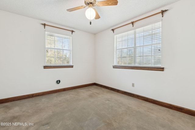 empty room featuring baseboards, carpet, a ceiling fan, and a textured ceiling