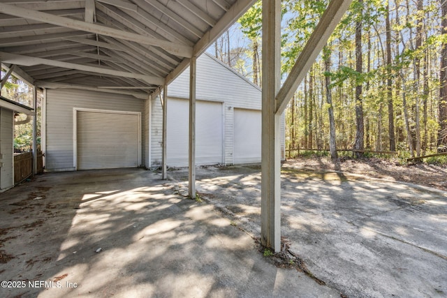 view of patio / terrace with a carport, a garage, and an outdoor structure