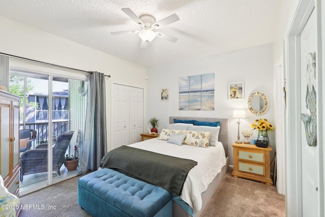 carpeted bedroom with access to outside, a ceiling fan, a closet, and a textured ceiling