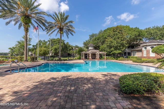 community pool featuring a pergola, a patio, and fence