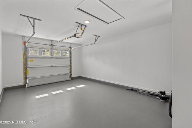 garage with a garage door opener and baseboards