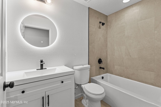 bathroom with vanity, shower / bathing tub combination, toilet, and a textured wall