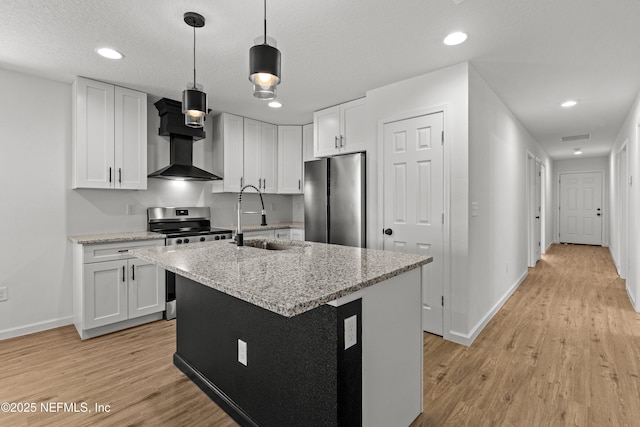 kitchen featuring a sink, white cabinets, light wood-type flooring, and stainless steel appliances