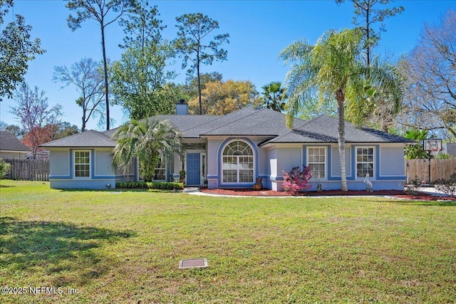 single story home with stucco siding, a chimney, a front lawn, and fence