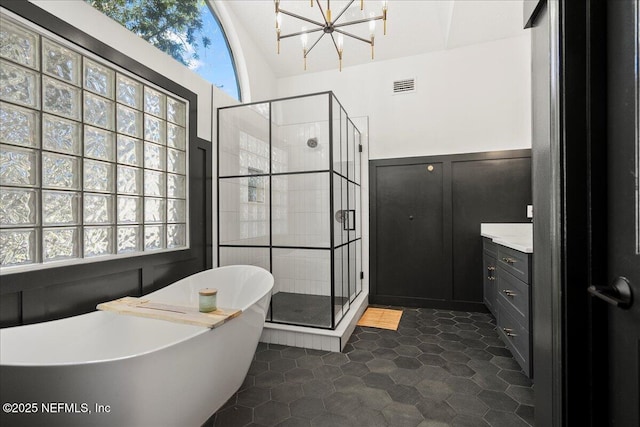 bathroom with vanity, a freestanding tub, visible vents, and a stall shower