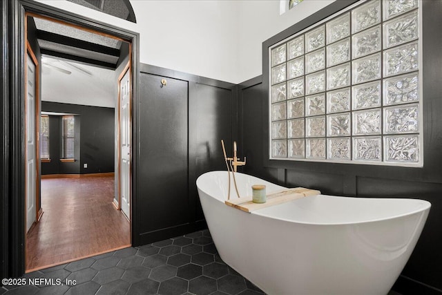 full bathroom with tile patterned floors and a soaking tub