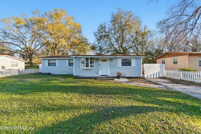 single story home with a front yard and fence