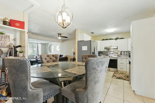 dining room featuring light tile patterned floors, a textured ceiling, and a ceiling fan