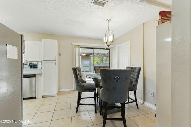 dining space featuring visible vents, baseboards, light tile patterned floors, a notable chandelier, and a textured ceiling