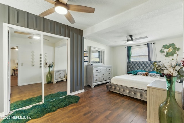 bedroom featuring ceiling fan, wood finished floors, and a textured ceiling