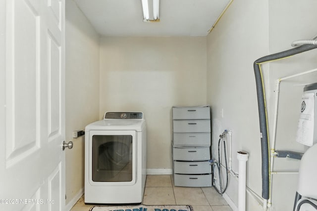 laundry area with laundry area, washer / clothes dryer, baseboards, and light tile patterned floors