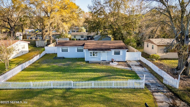 back of property featuring a fenced front yard and a yard