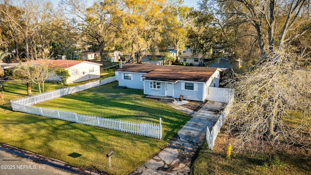 exterior space featuring a front lawn and a fenced front yard