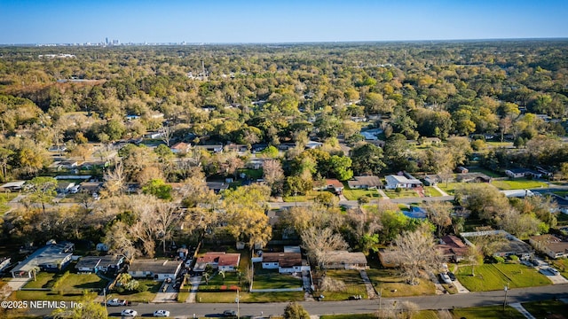 drone / aerial view with a wooded view