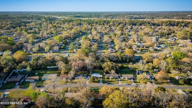 birds eye view of property featuring a forest view