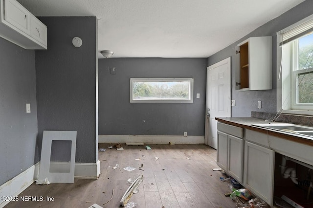 kitchen featuring baseboards and light wood finished floors