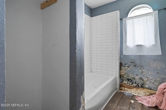 full bathroom with a textured wall