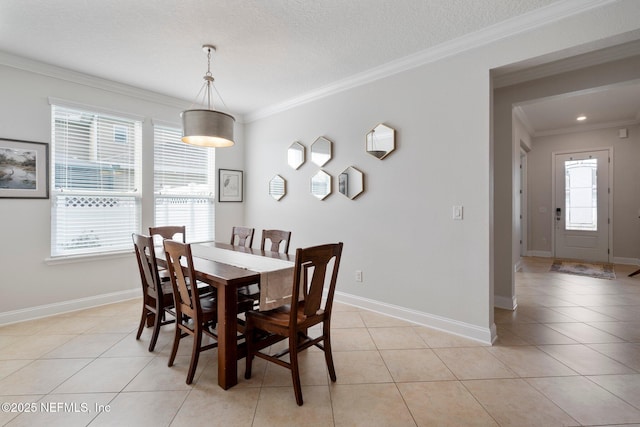 dining space featuring light tile patterned flooring, baseboards, and ornamental molding