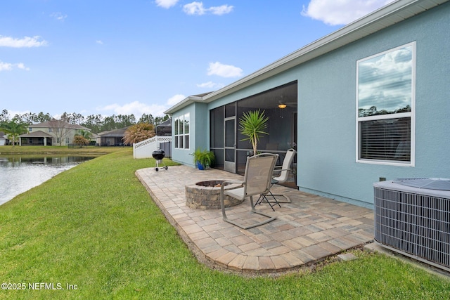 view of patio with central air condition unit, a water view, a sunroom, and an outdoor fire pit