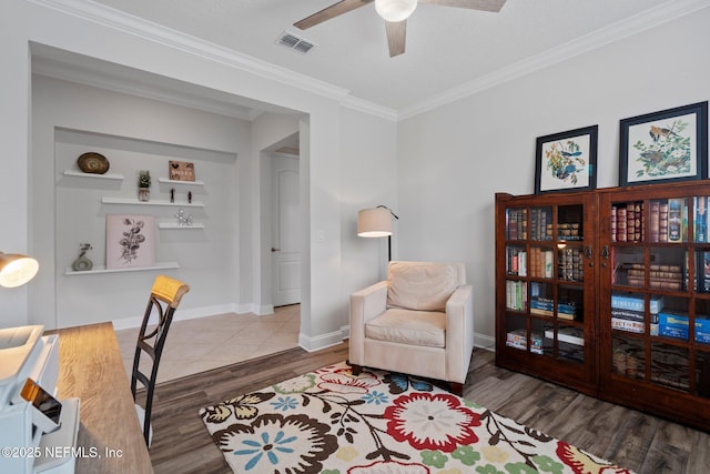 office featuring visible vents, wood finished floors, crown molding, baseboards, and ceiling fan