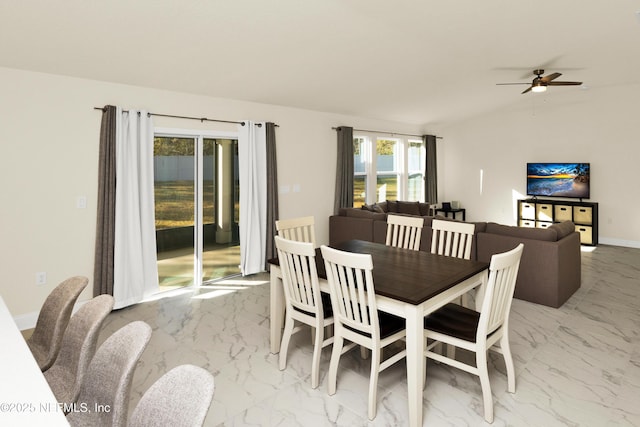 dining space with baseboards, marble finish floor, and ceiling fan