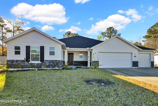 view of front of property with a front lawn, concrete driveway, roof with shingles, stone siding, and an attached garage