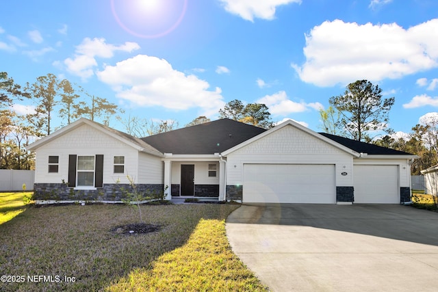 ranch-style home with a front yard, an attached garage, stone siding, and driveway