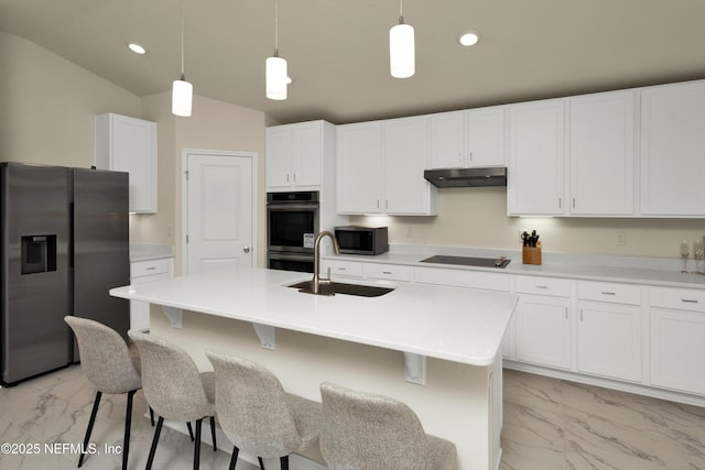 kitchen with under cabinet range hood, stainless steel appliances, marble finish floor, white cabinetry, and a sink