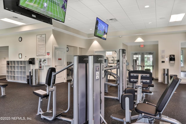 exercise room featuring visible vents and a paneled ceiling