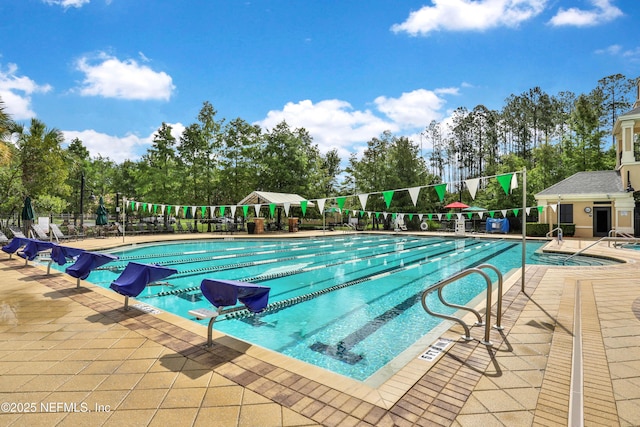 pool featuring a patio area and fence