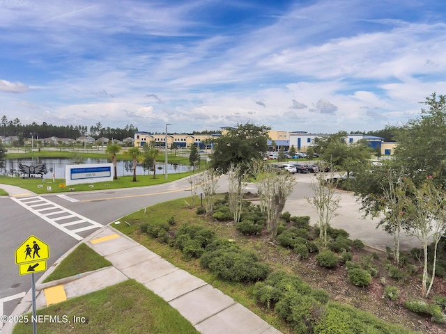 birds eye view of property with a water view and a residential view