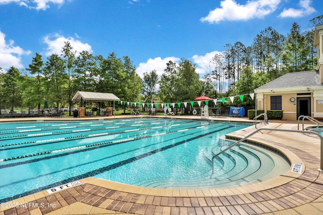 pool featuring a patio and fence