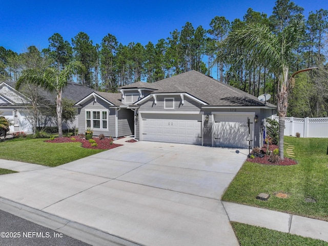 view of front of home with a shingled roof, fence, a front yard, a garage, and driveway