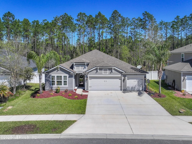 view of front of house featuring a front lawn, fence, roof with shingles, concrete driveway, and an attached garage