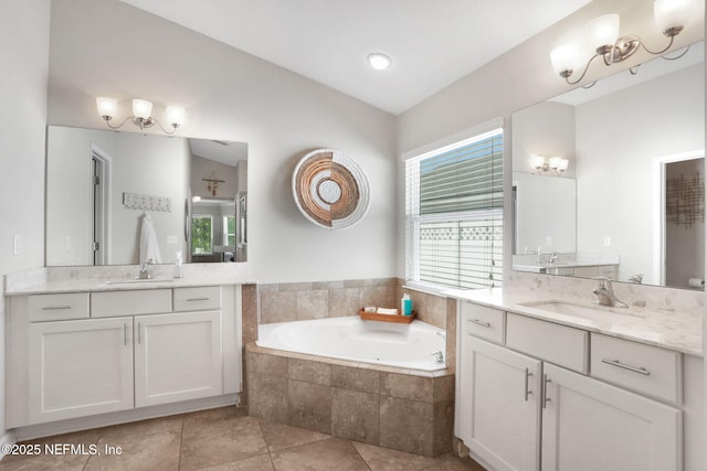 full bathroom featuring a bath, tile patterned floors, two vanities, and a sink