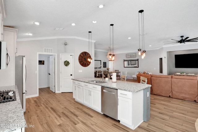 kitchen with visible vents, light wood-style flooring, a ceiling fan, a sink, and stainless steel appliances