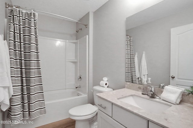 bathroom featuring vanity, toilet, wood finished floors, and shower / bath combo with shower curtain