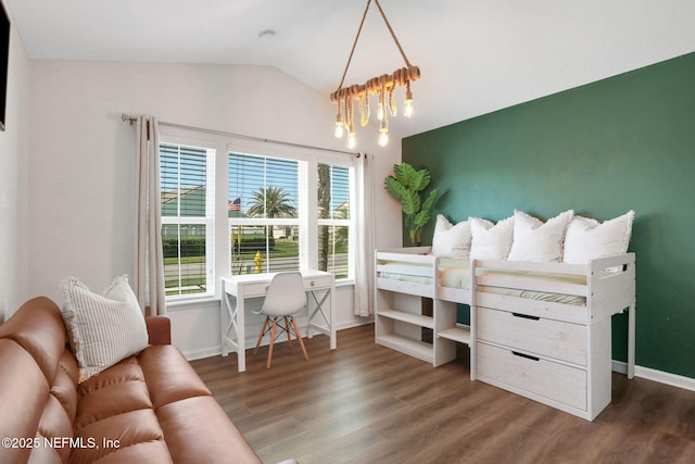 bedroom featuring a notable chandelier, vaulted ceiling, baseboards, and wood finished floors