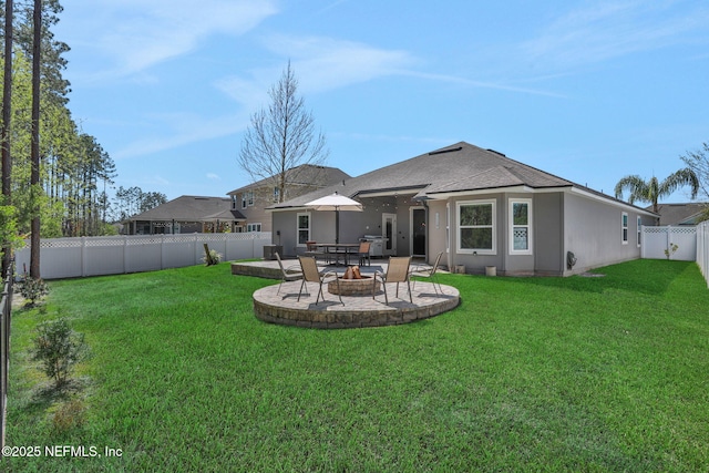 rear view of house with a fenced backyard, a lawn, a patio, and stucco siding