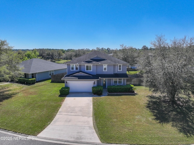 traditional home featuring fence, a front yard, stucco siding, a garage, and driveway