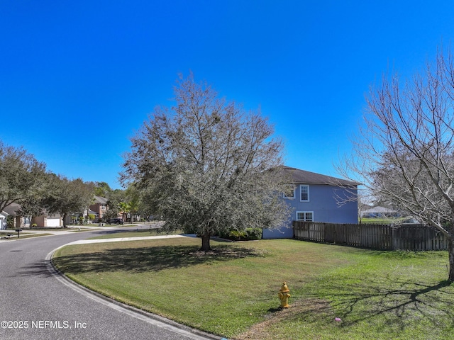 exterior space with a yard and fence