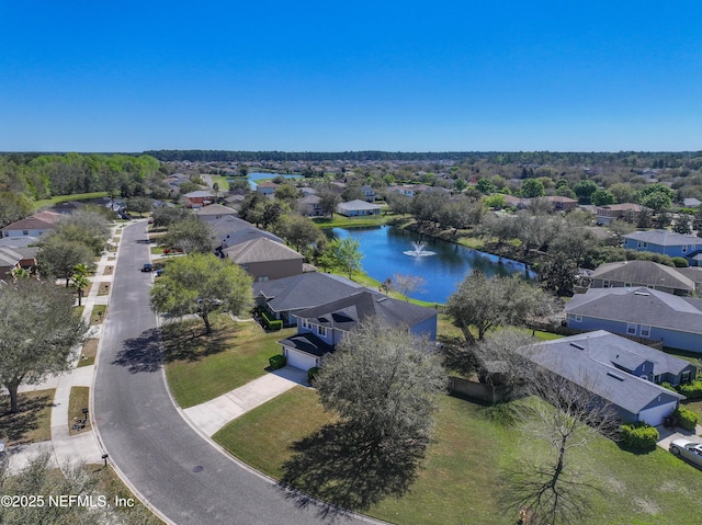 drone / aerial view featuring a residential view and a water view