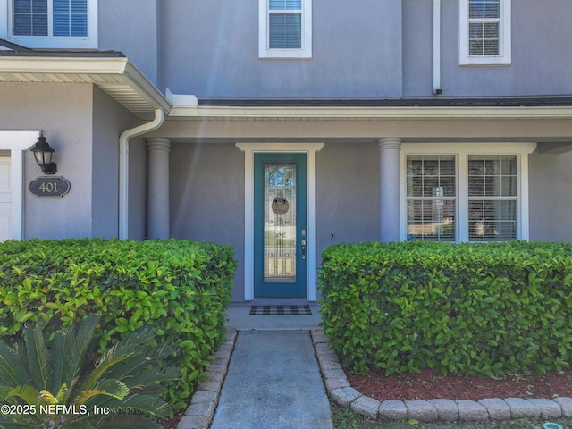 entrance to property with stucco siding