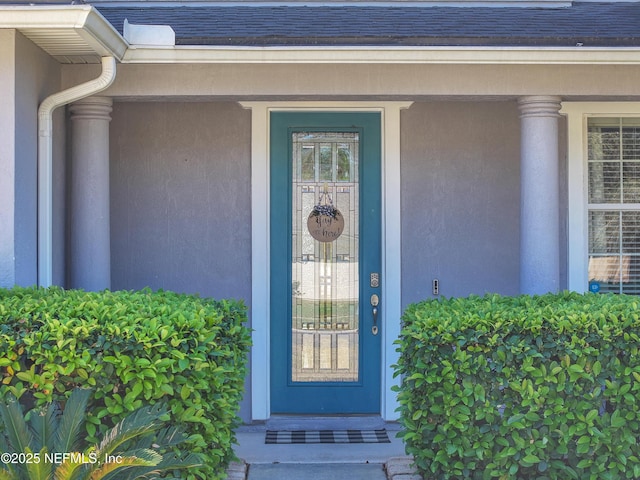 property entrance with stucco siding