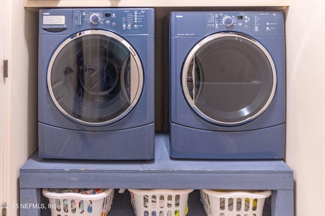 clothes washing area with laundry area and washing machine and clothes dryer